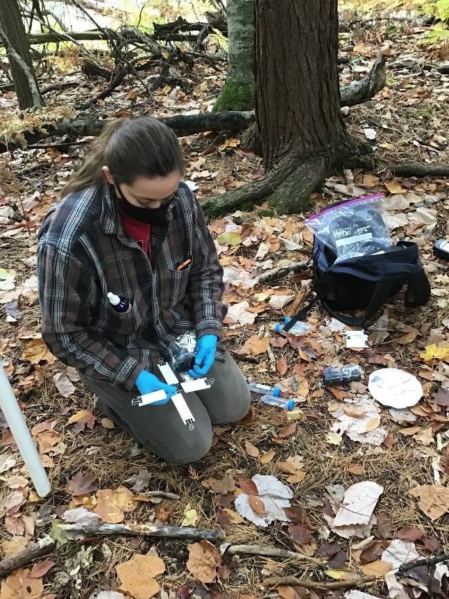 Graduate student, Meg Sanders, exchanging slides on a trap for eDNA analysis.